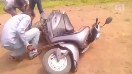 Poisonous snake stuck in motorbike engine in India