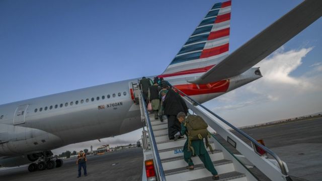 People on a plane with the American flag stamped on its back