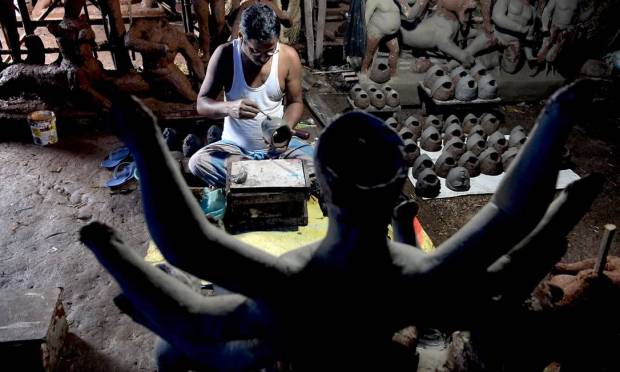 A craftsman attends a clay statue of Hindu goddess Durga before the Durga Puja festival in Vashi, Mumbai Image: INDRANIL MUKHERJEE / AFP